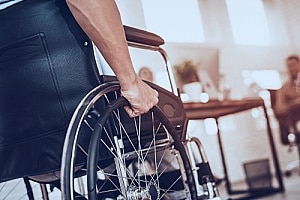 a man in a wheelchair who is going to see an attorney after his injury