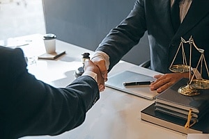 an attorney shaking hands with a personal injury client