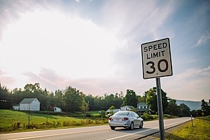 a road with a speed limit sign where a motorcycle accident took place