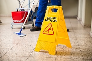 a wet floor sign in an office where an employee is filing a personal injury claim