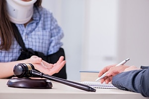 a woman speaking to an attorney after learning what to look for in a personal injury attorney