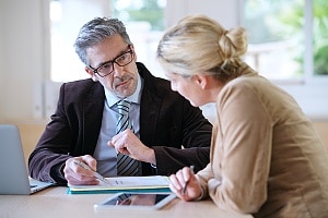 a woman speaking to her attorney about reaching a car accident settlement