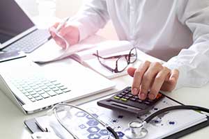 Car accident attorney calculating medical bills from car accident