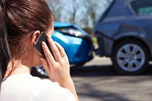 Woman involved in a car accident calling her Santa Fe personal injury attorney