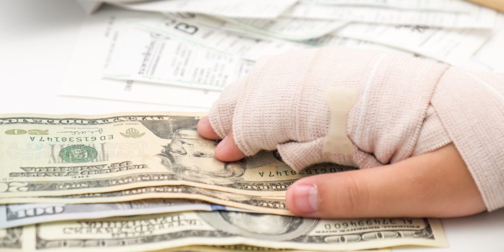 A car accident victim with broken hand and dollar bills