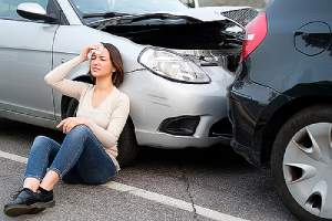 Injured girl after car accident in a street. You are liable for your medical bills