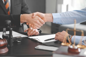 attorney and client shake hands before going over details regarding the personal injury case