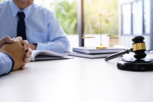 attorney takes notes for the personal injury trial while assistant waits patiently