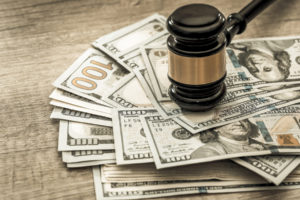 gavel sits on top of the wad of cash awarded to the winner of the personal injury case