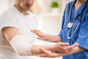 patient has bandage being applied on him after susatining injury in a car accident