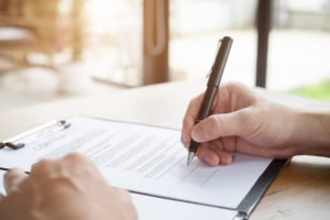 person signs document that is used in personal injury case along with the demand letter