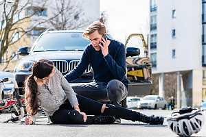 Passerby helping a car accident victim. Medical records can also be used to back up claims in the settlement letter